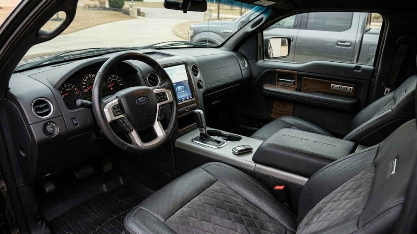 Ford F-150 4x4 interior with premium seats, dash cam setup, and organized cabin storage upgrades for daily driving.s