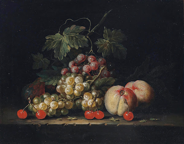 Grapes peaches and cherries on a stone ledge