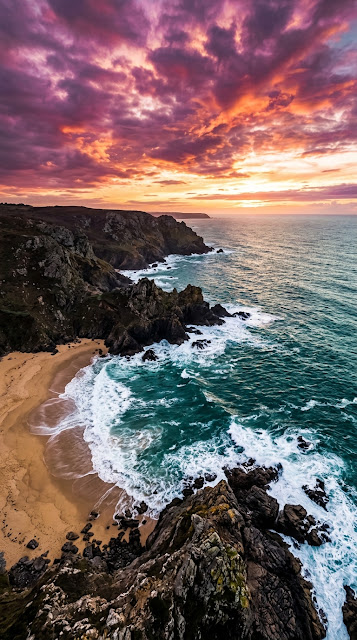Aerial Coastline With Crashing Waves And Vibrant Purple Sunset - Free mobile Wallpaper