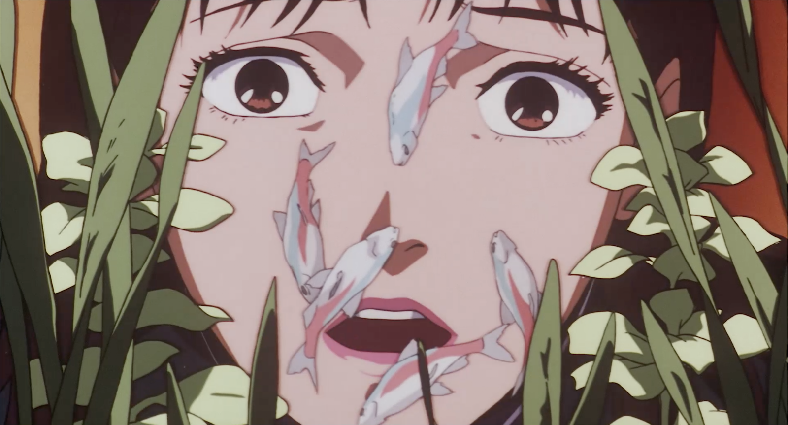 Close-up of Mima's face surrounded by aquarium fish and plants