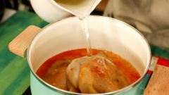 Bắc nồi lên bếp, cho vào 2 muỗng canh dầu màu điều, thêm 10gr hành tím và 10gr tỏi băm vào phi lên cho thơm. Gắp thịt vịt vào nồi, thêm 600ml nước hầm xương gà, 400ml nước dừa vào đun sôi, sau đó hạ nhỏ lửa hầm 45 phút cho thịt vịt thật mềm.