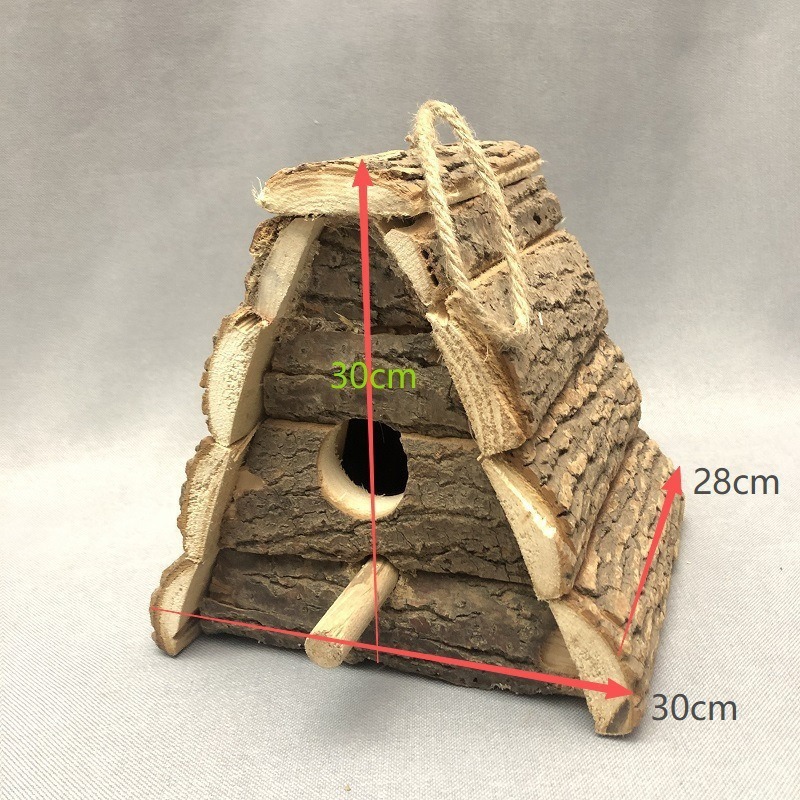 Rustic wooden birdhouse with bark