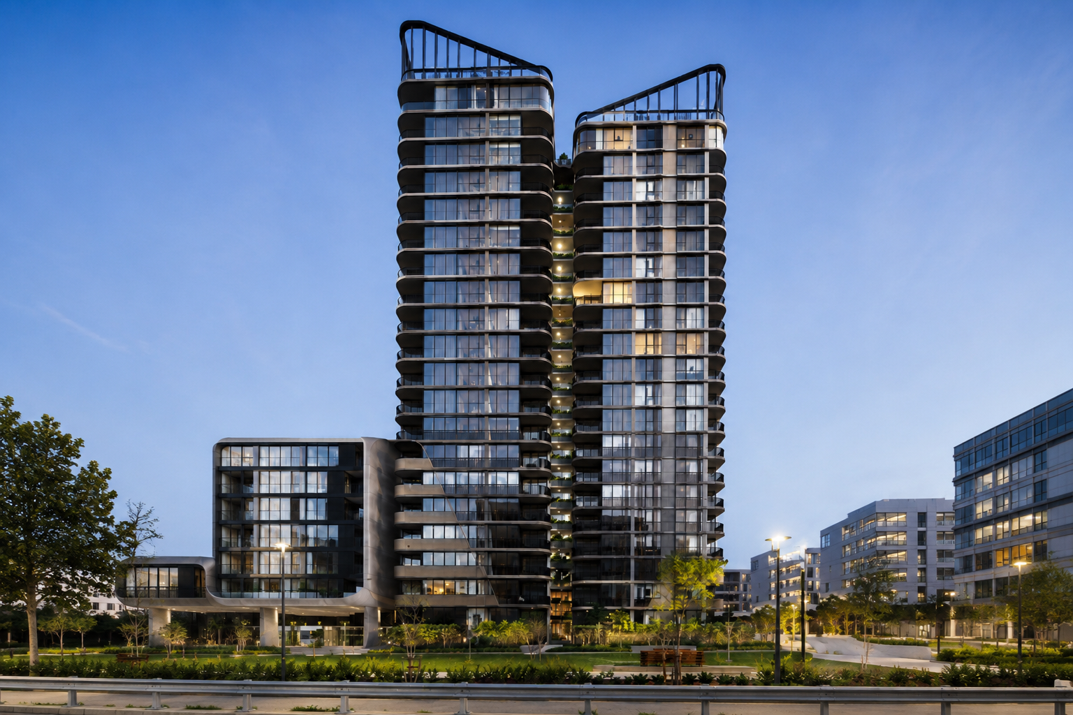 Sculptural twin residential towers at blue hour