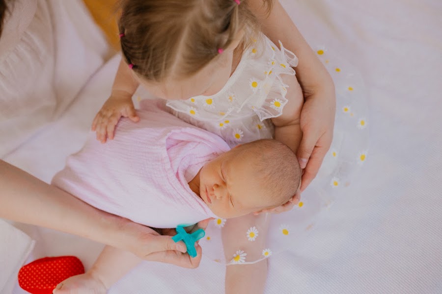 Newborn detail — tiny fingers in soft afternoon light