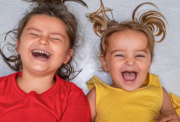Two little girls laughing with joy
