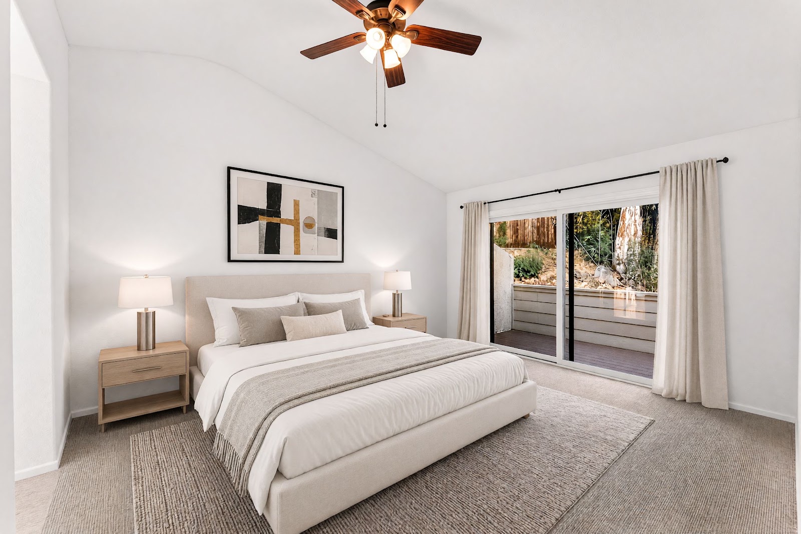 Primary bedroom with vaulted ceiling and ceiling fan