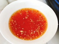 Băm nhuyễn 3 tép tỏi và ớt. Pha nước mắm: cho 8 muỗng canh nước mắm, 2 muỗng canh đường, 3 muỗng nước sôi để nguội, nước cốt 1 quả chanh vào tô. Khuấy đều cho đường tan hết. Cho tỏi ớt vào bát nước mắm. Thịt chín, để cho thịt nguội bớt rồi thái lát mỏng.