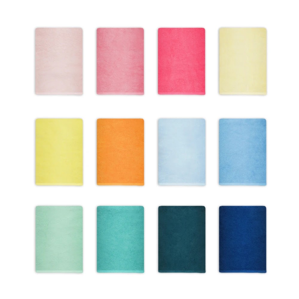 Twelve Momomi Happy Towels laid flat in a colour swatch grid, from soft pastels to deep navy