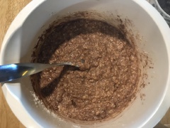 Cho bột caocao và baking soda cùng bột nở vào. Trộn một lần thật nhanh nữa rồi cho chocolate chip vào. Lót khuôn muffin vào khay muffin. Nếu không có khuôn giấy muffin thì bạn có thể cắt giấy nến rồi lót vào như hình.