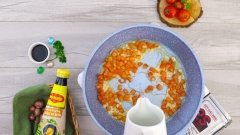 Giữ nguyên chảo dầu, cho vào 10gr hành tây phi thơm, sau đó cho 100gr cà chua (cắt hạt lựu) vào đảo đều 3 phút đến khi cà chua chín nhuyễn. Kế đến, cho vào 200ml nước, nấu sôi.
