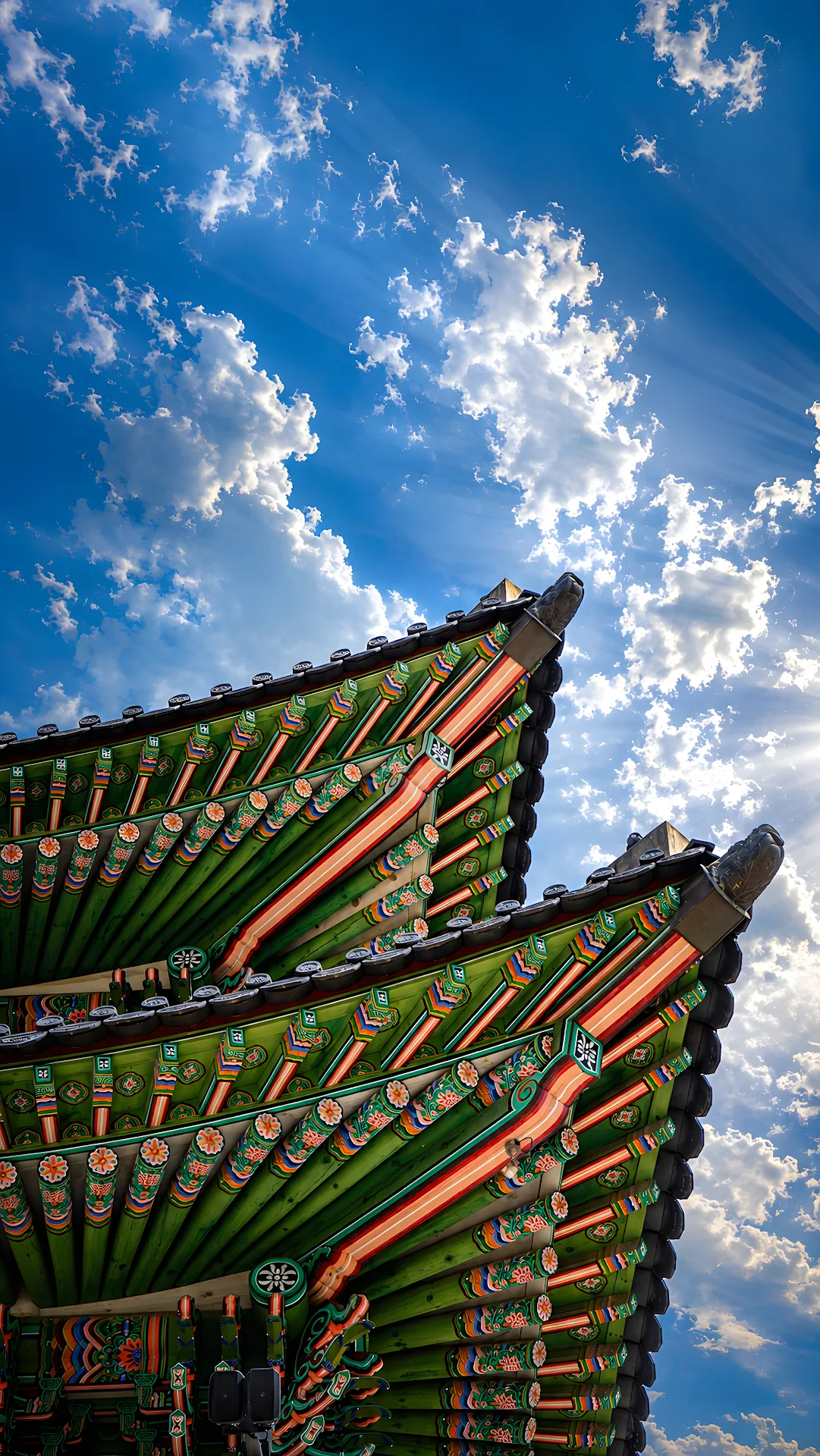 Ornate Traditional Wooden Roof Architecture Against Blue Sky - Free 4K mobile Wallpaper
