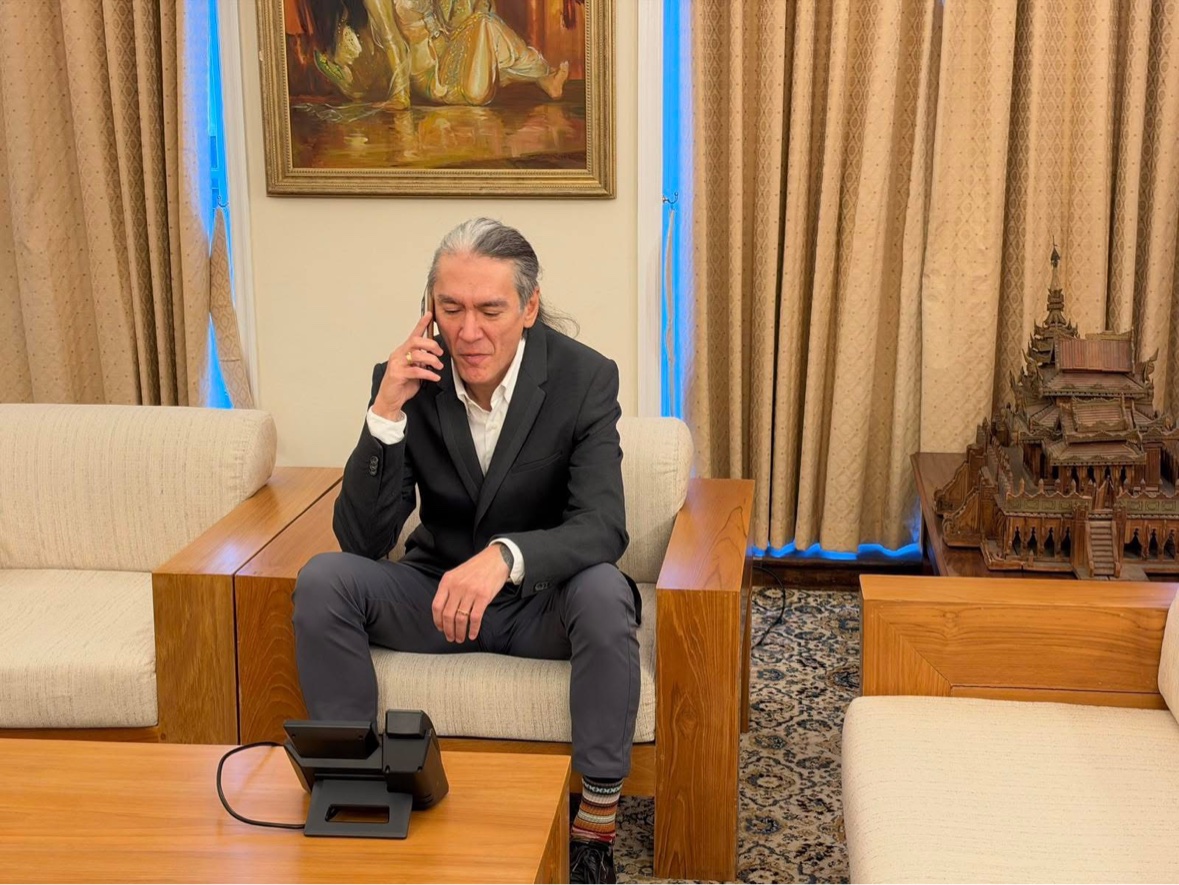 Kim Aris speaking on the telephone at the Myanmar Embassy in London