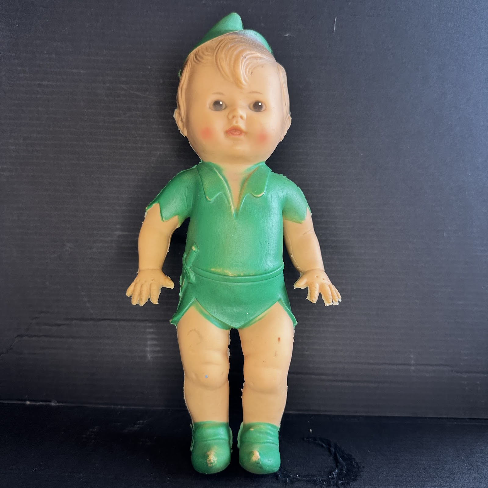 Vintage 1950s–60s rubber Peter Pan squeak doll in Campbell Kid proportions, wearing green tunic and pointed hat with molded dagger on hip