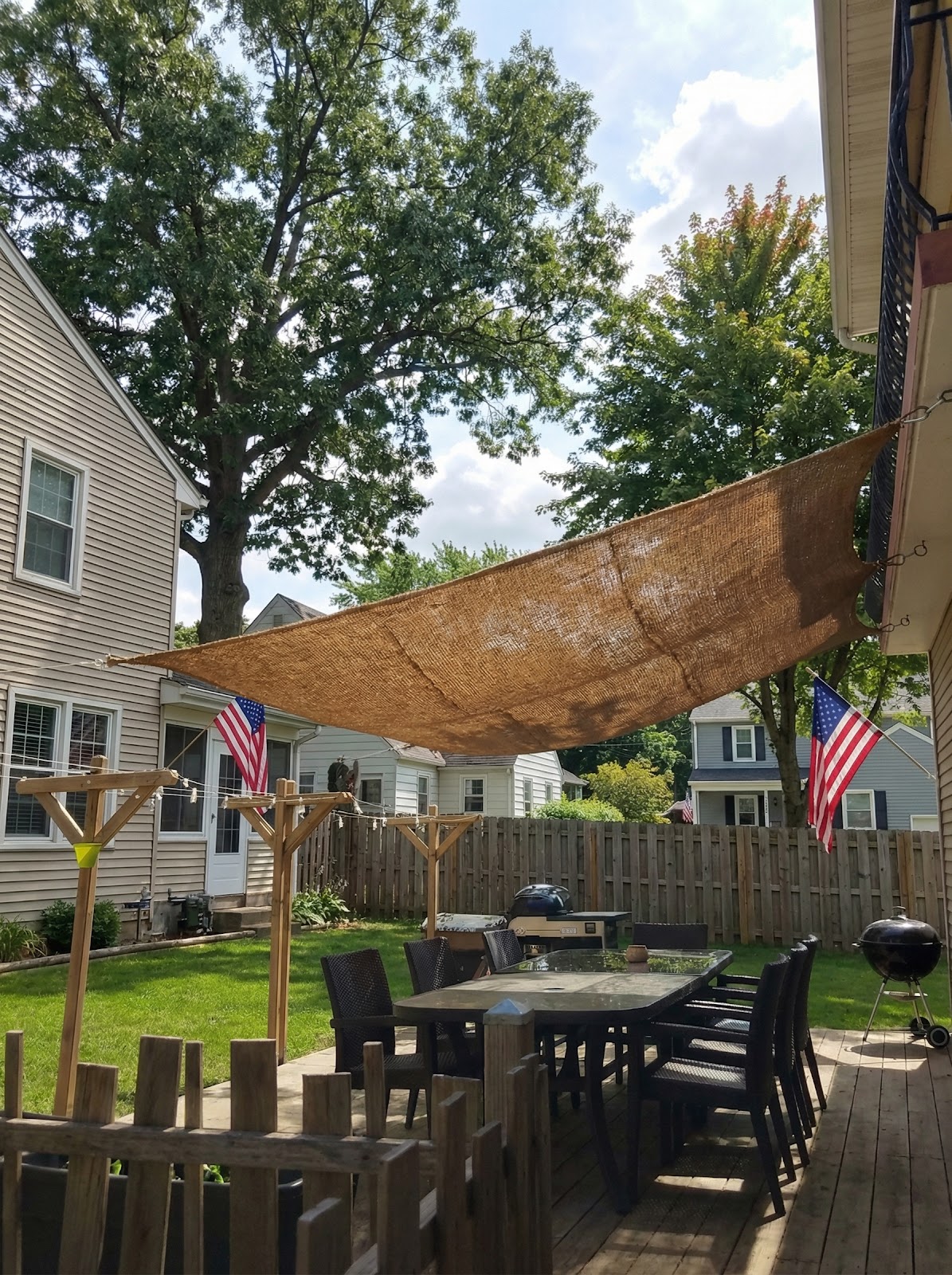 Backyard rectangular coir shade sail installed over patio dining table