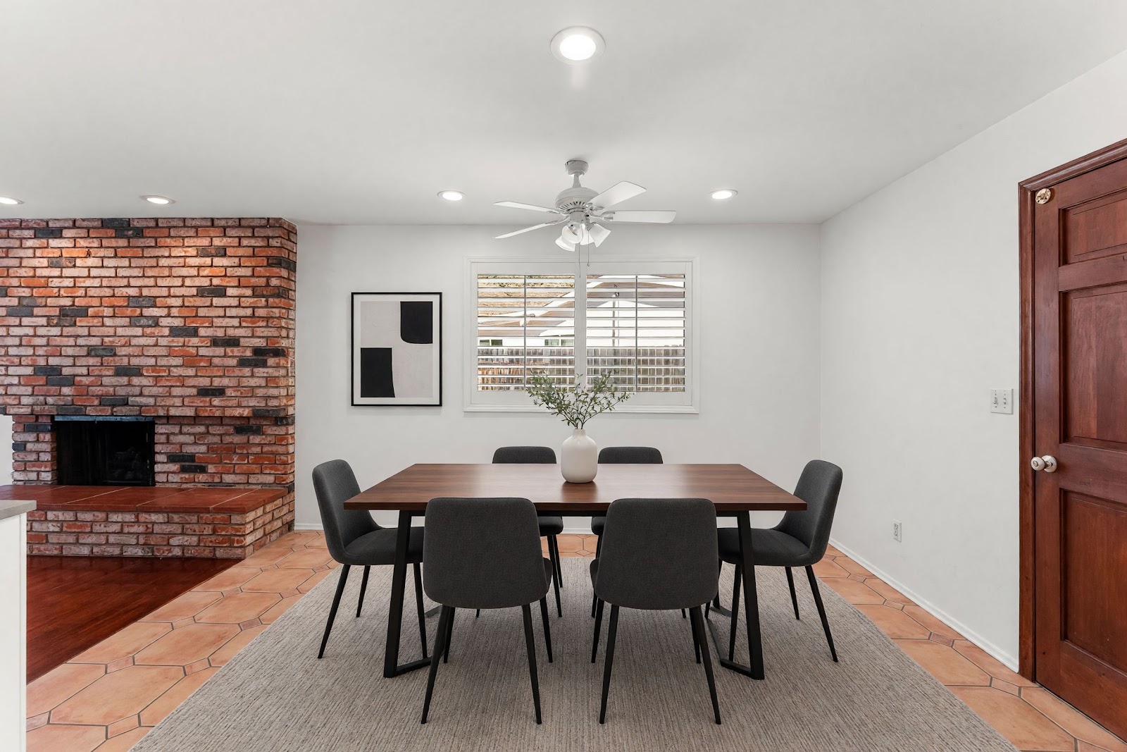 Dining area next to the brick fireplace