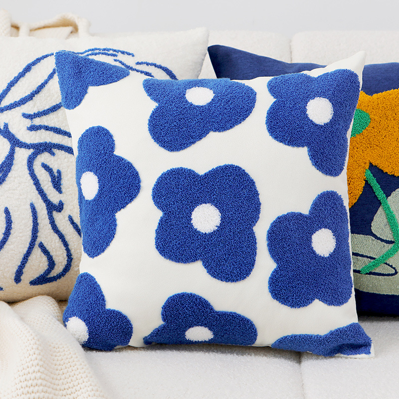 Cushion cover with embroidered daisy motif
