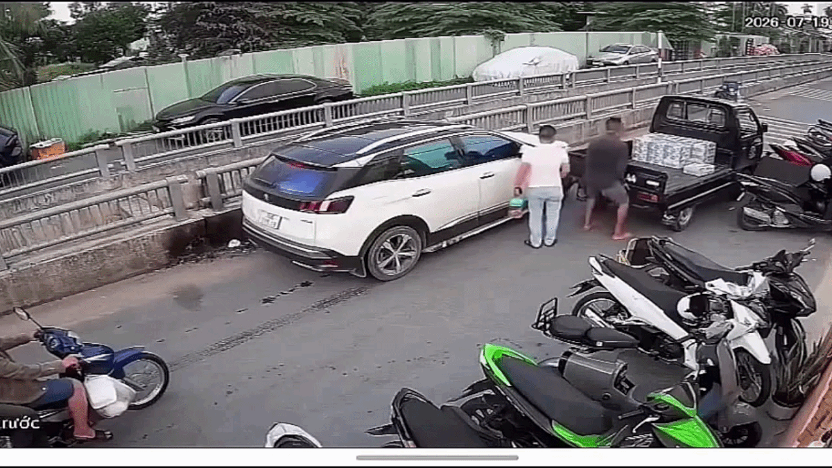 Clip: Người đàn ông dùng tay không nhấc đuôi xe tải cho ô tô đi qua - Báo Tiền Phong
