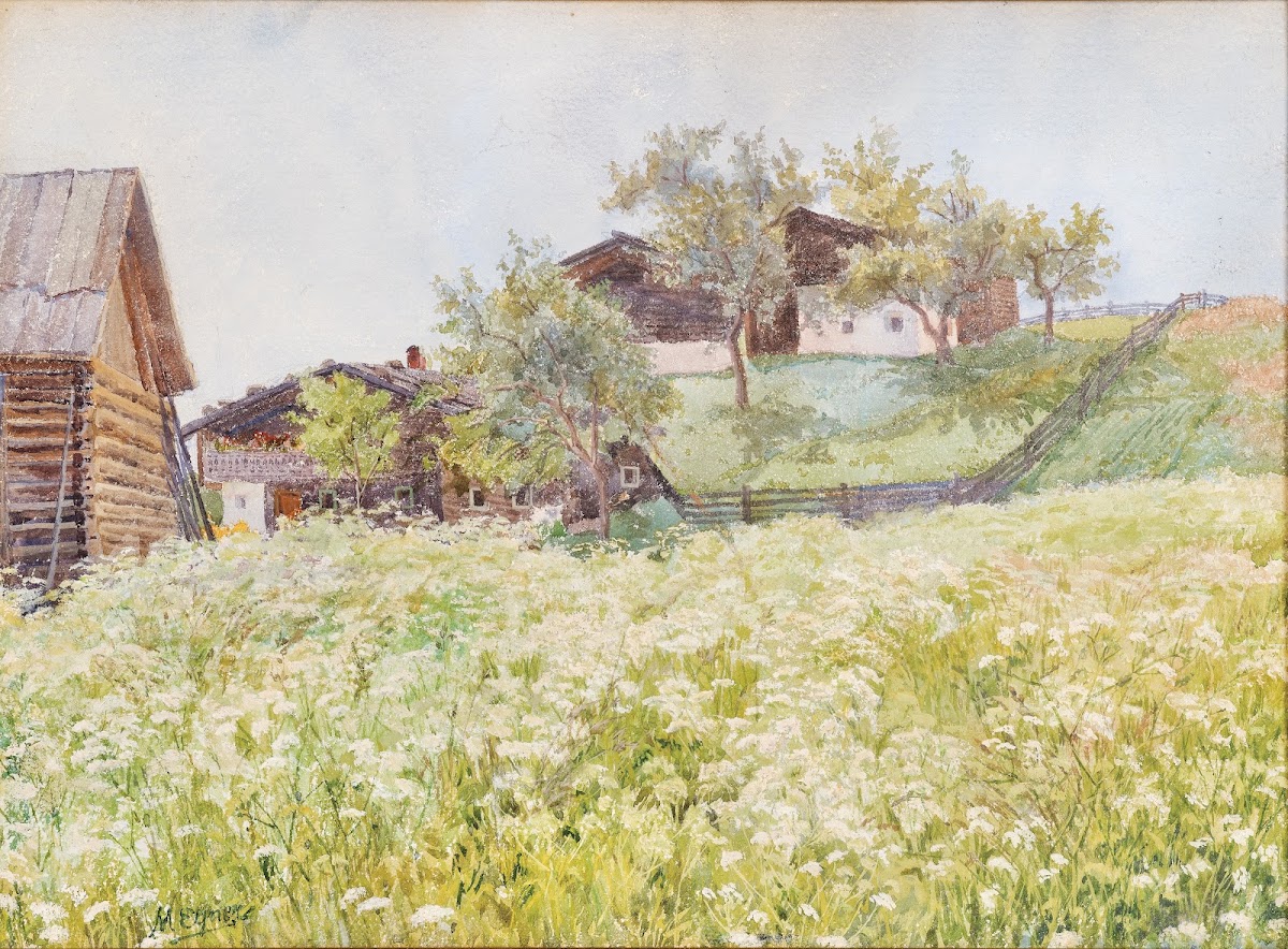 Farm houses a white blooming field in front of it