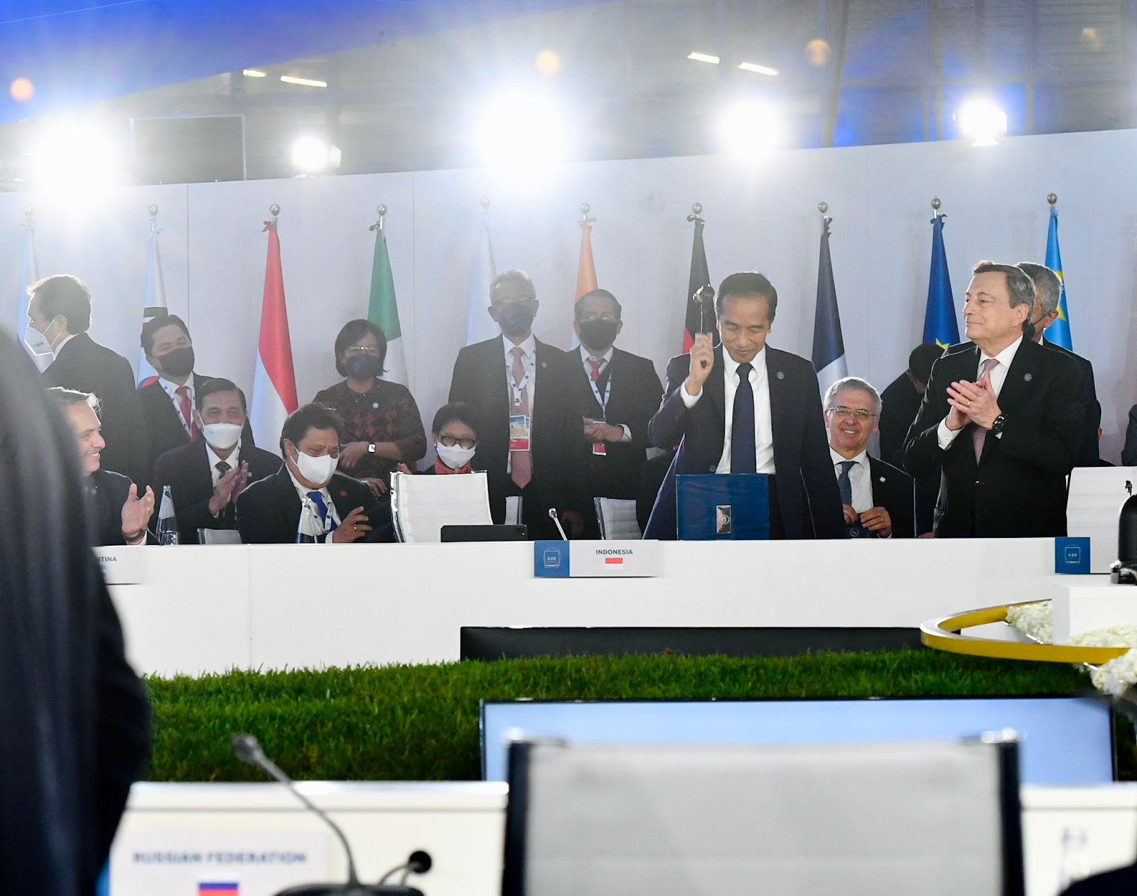 President Joko Widodo at G20 Rome Summit receiving presidency handover in a conference room with bright lights. G20 Indonesia, Indonesia Sustainable Energy Transition, Indonesia Sustainable Development Agenda. CarbonEthics Indonesia