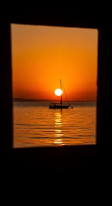 Sailboat Silhouette Framed by Intense Orange Sunset