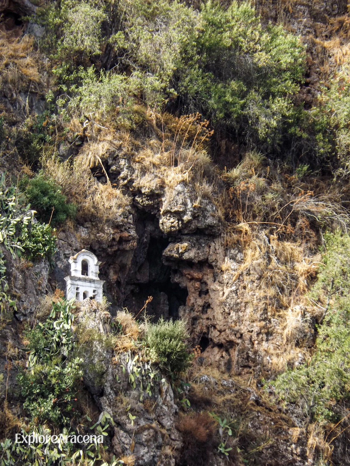 Architecture built into a rocky cave opening in Alájar