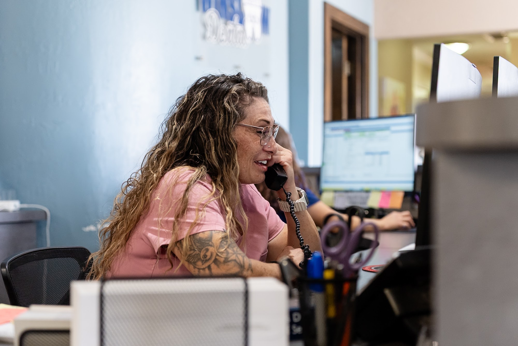 A Winslow Dental team member on the phone at her desk