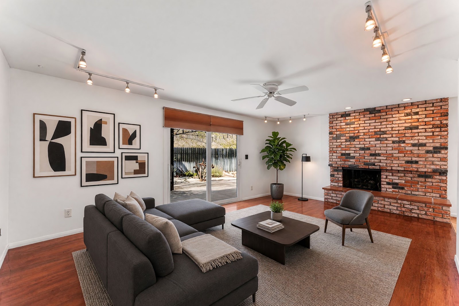 Living room with brick fireplace and hardwood floors