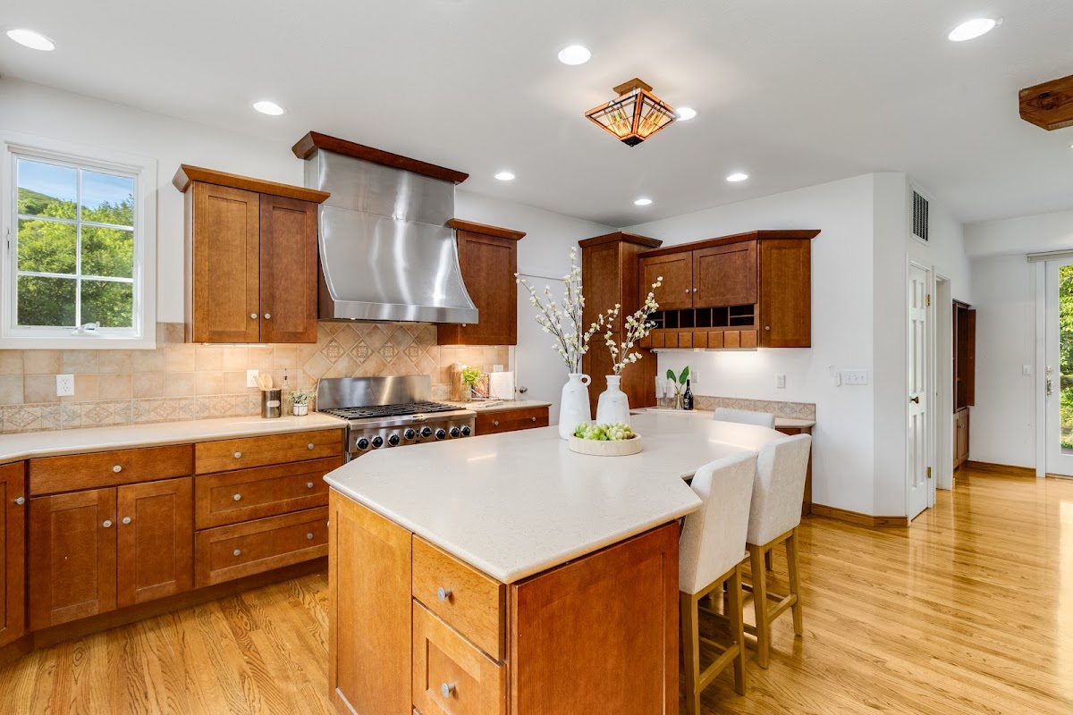 Kitchen with island and natural window light — by 3 Eye Media