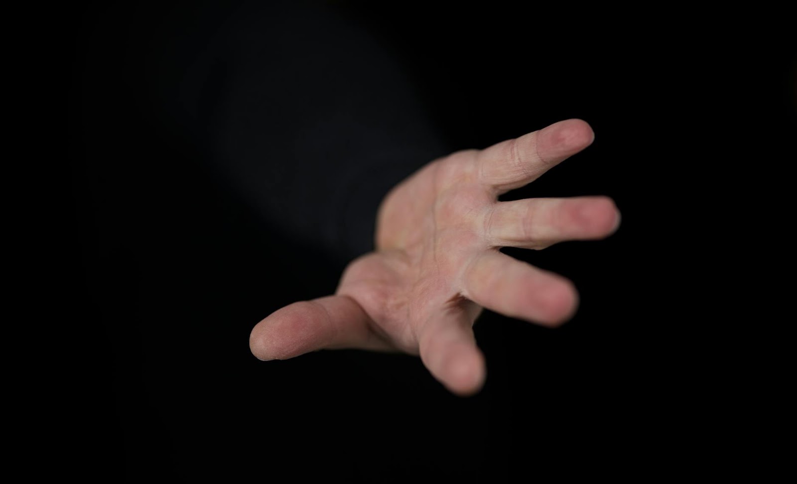 An abstract image showing human hands reaching out, with digital connections, representing the intersection of human and AI dating apps.