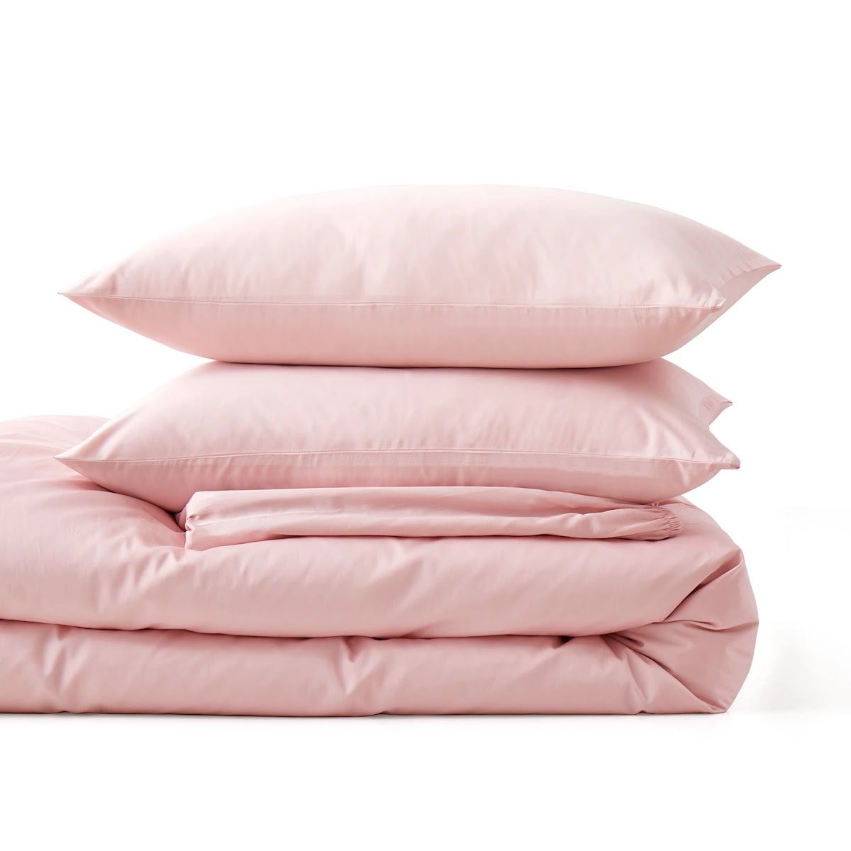 Folded pink anti-allergy duvet with two stacked pillows on a plain white background