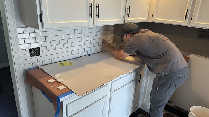 Gavin Dies installing kitchen tile backsplash in Eureka IL