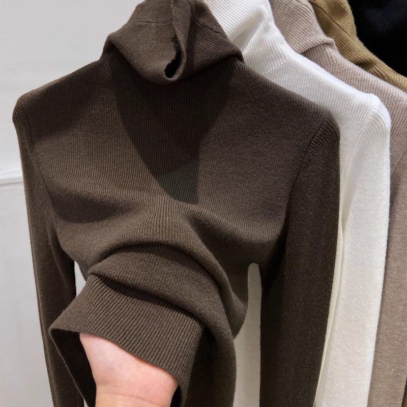 Slimming women's knitted sweater with a high collar
