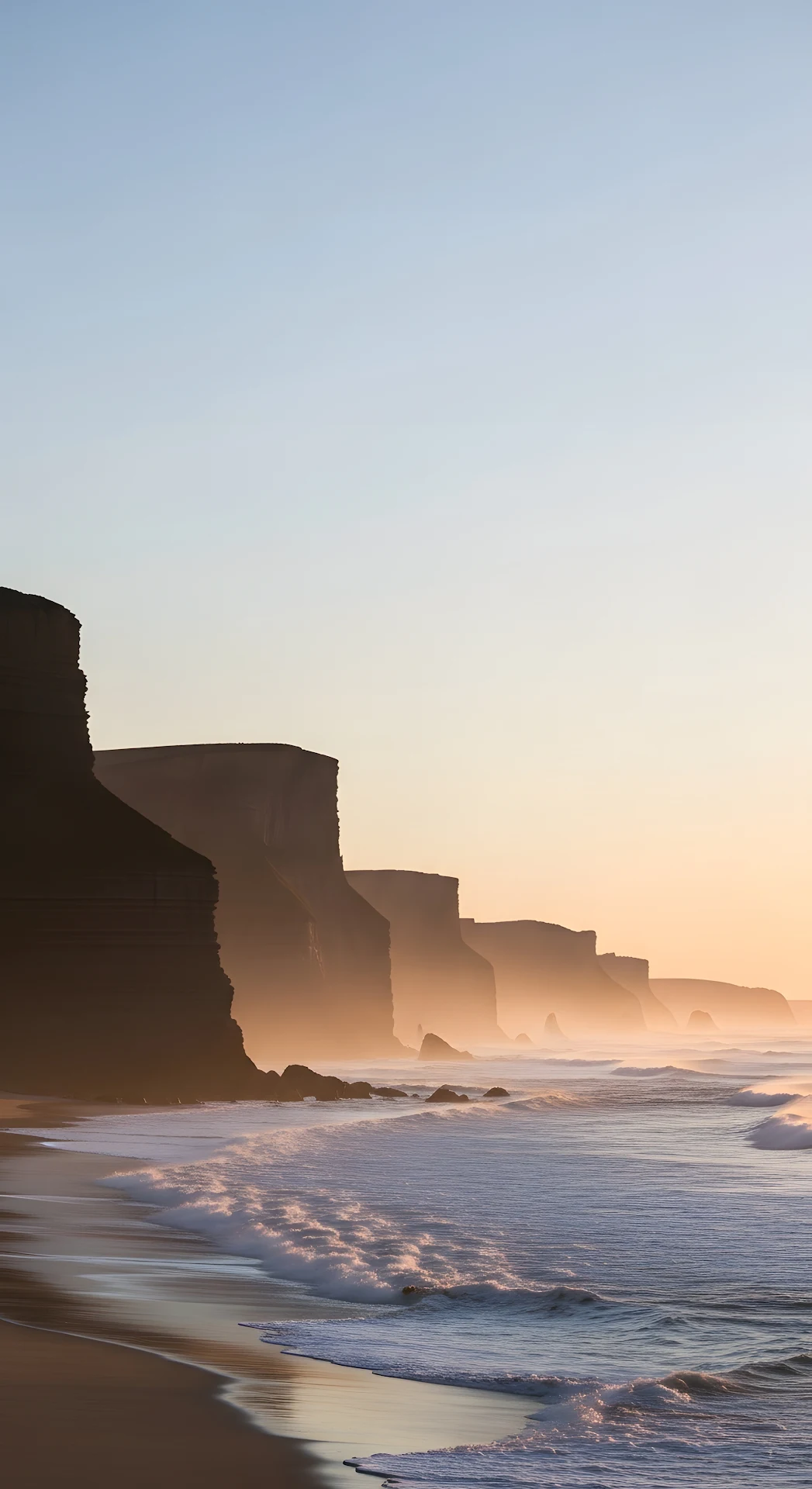 Misty Coastal Landscape of Towering Cliffs Over a Sandy Beach at Sunset Twilight - Free 4K mobile Wallpaper