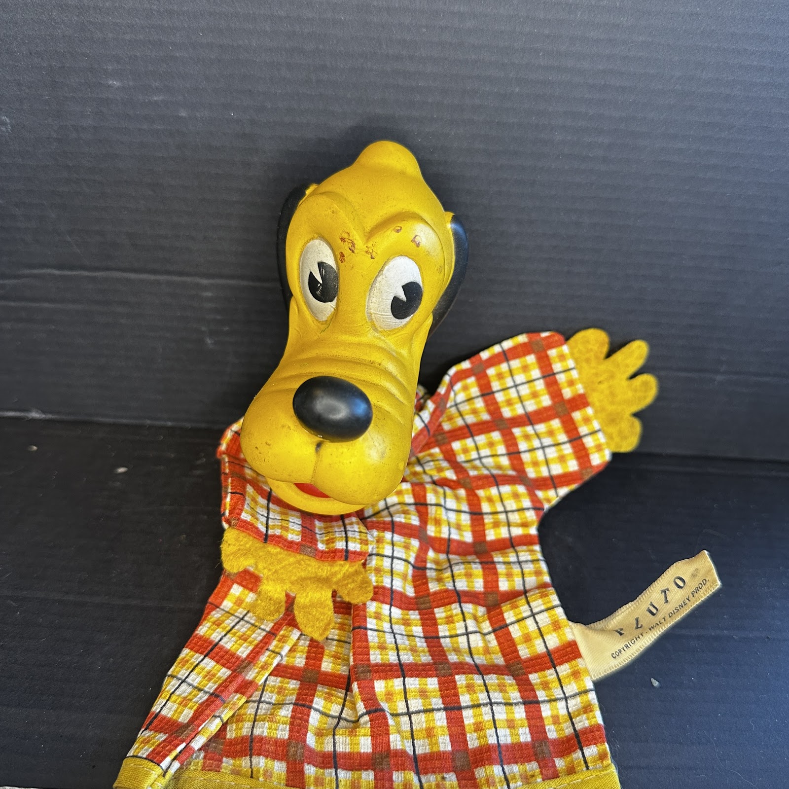 Vintage Walt Disney Productions Pluto the Dog hand puppet from the 1950s–1960s, approximately 9 inches tall, with original copyright tag