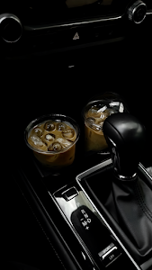 Iced Coffee Cups in Car Center Console at Night