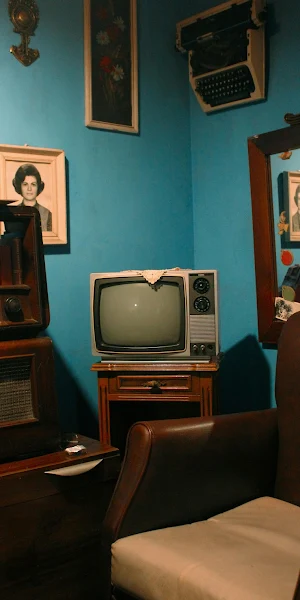 Old TV Set In Teal Room 4K iPhone Wallpaper Background
