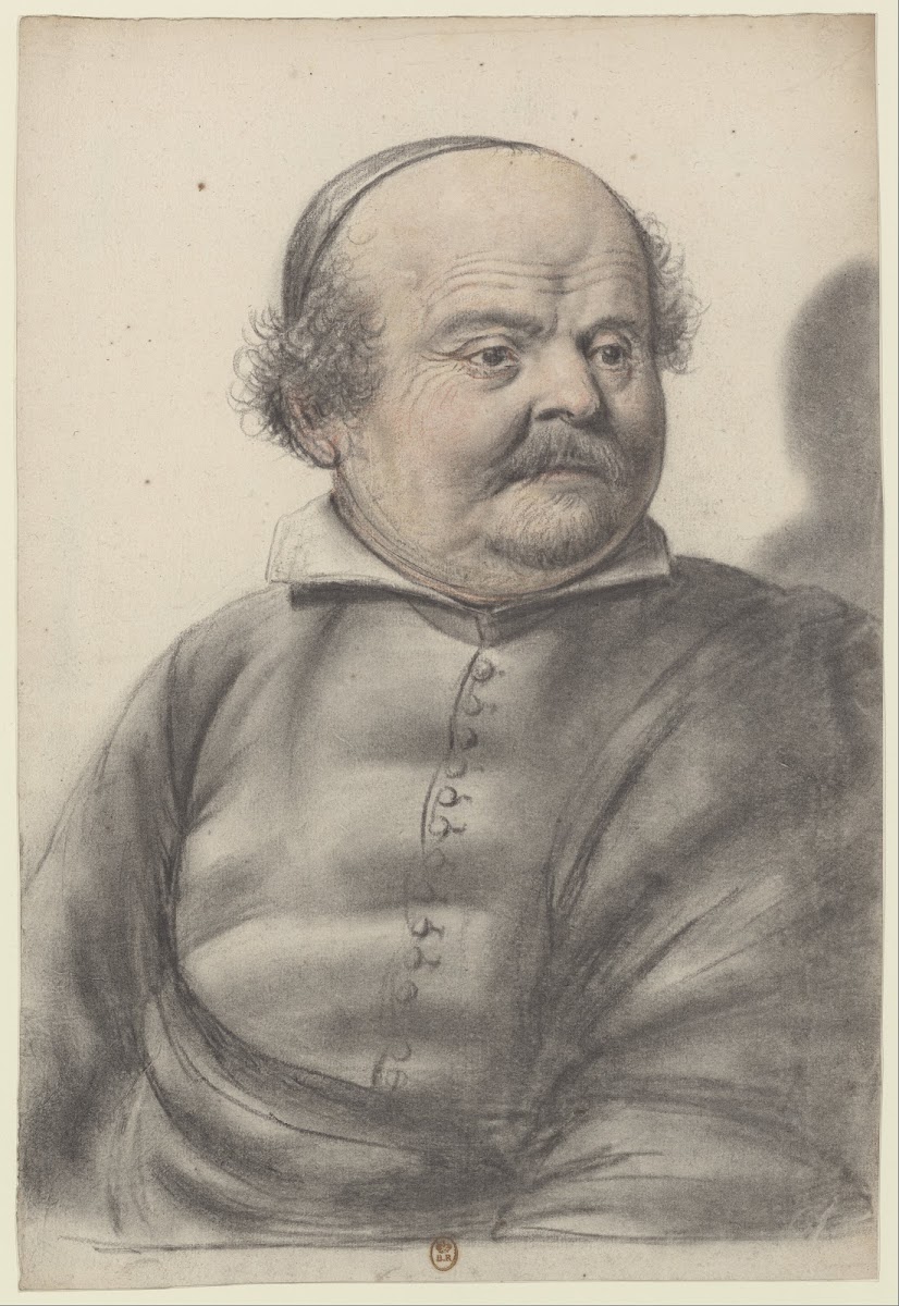 Homme au visage rond portant moustaches et royale coiffé dune calotte la tête de