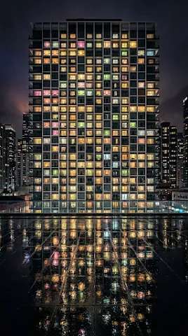 Modern Apartment Building with Colorful Windows at Night