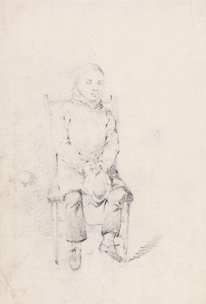 Boy Sitting Holding a Cap