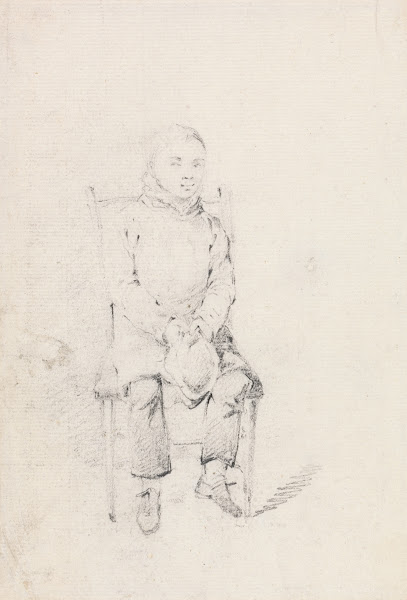 Boy Sitting Holding a Cap