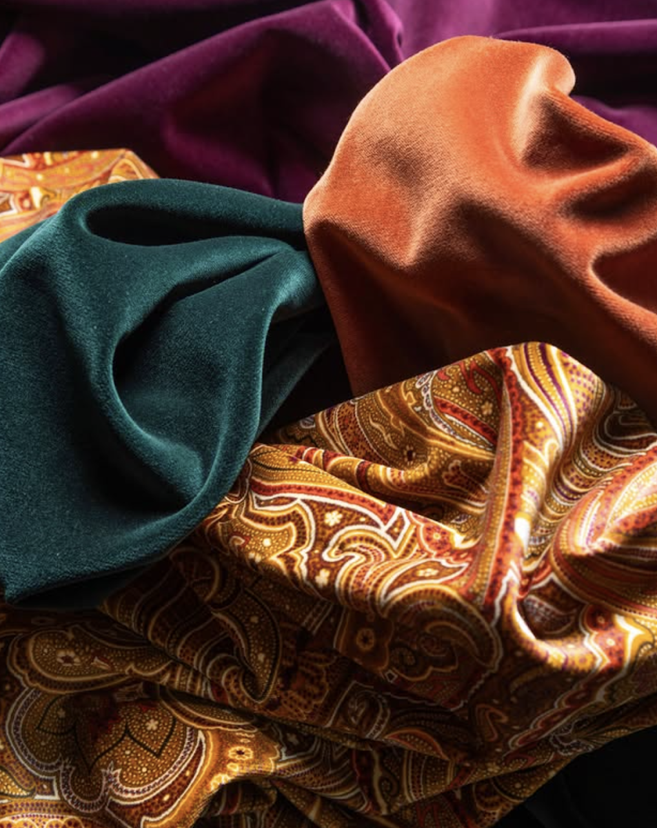 Scabal Velvet Collection fabric swatches in teal, burnt orange, and deep plum — luxury velvet options for bespoke jackets at Bespoke By CB in Miami