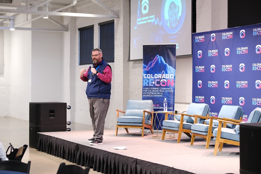 Speaker on stage at a past Colorado RE•CON event