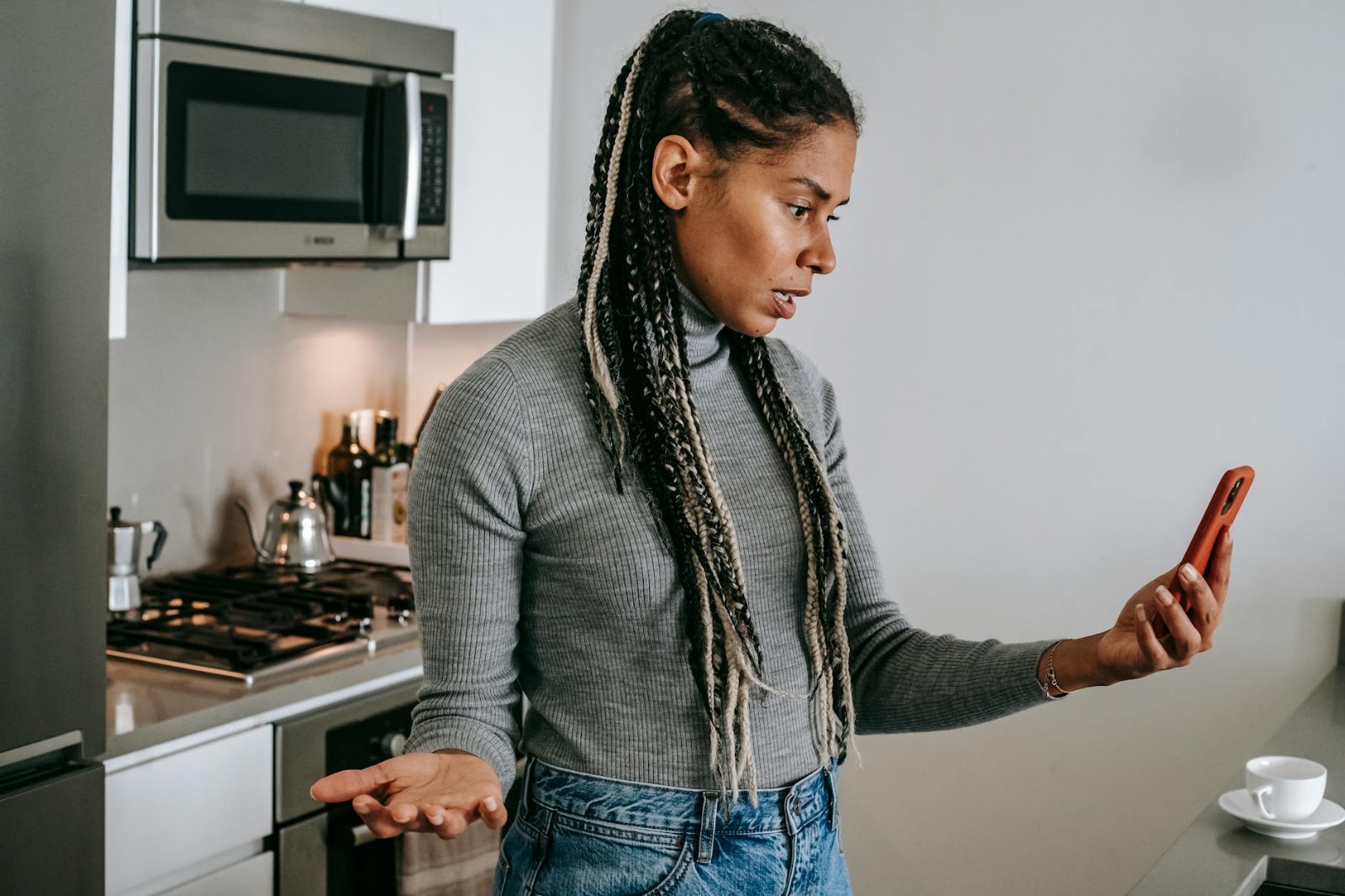 A woman looking confused at her phone, questioning the authenticity of messages in AI-powered dating apps.