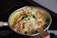 Cho nui, bông cải xanh và tôm vào hỗn hợp cheese, trộn đều để lớp sốt phô mai bám đều lên từng hạt nui. Bày ra chén, rắc thêm chút breadcrumb đã chuẩn bị từ trước và ít ngò là đã có thể thưởng thức rồi.