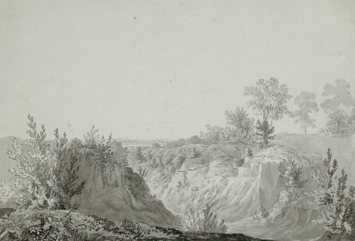View of a valley with two figures seated on a path
