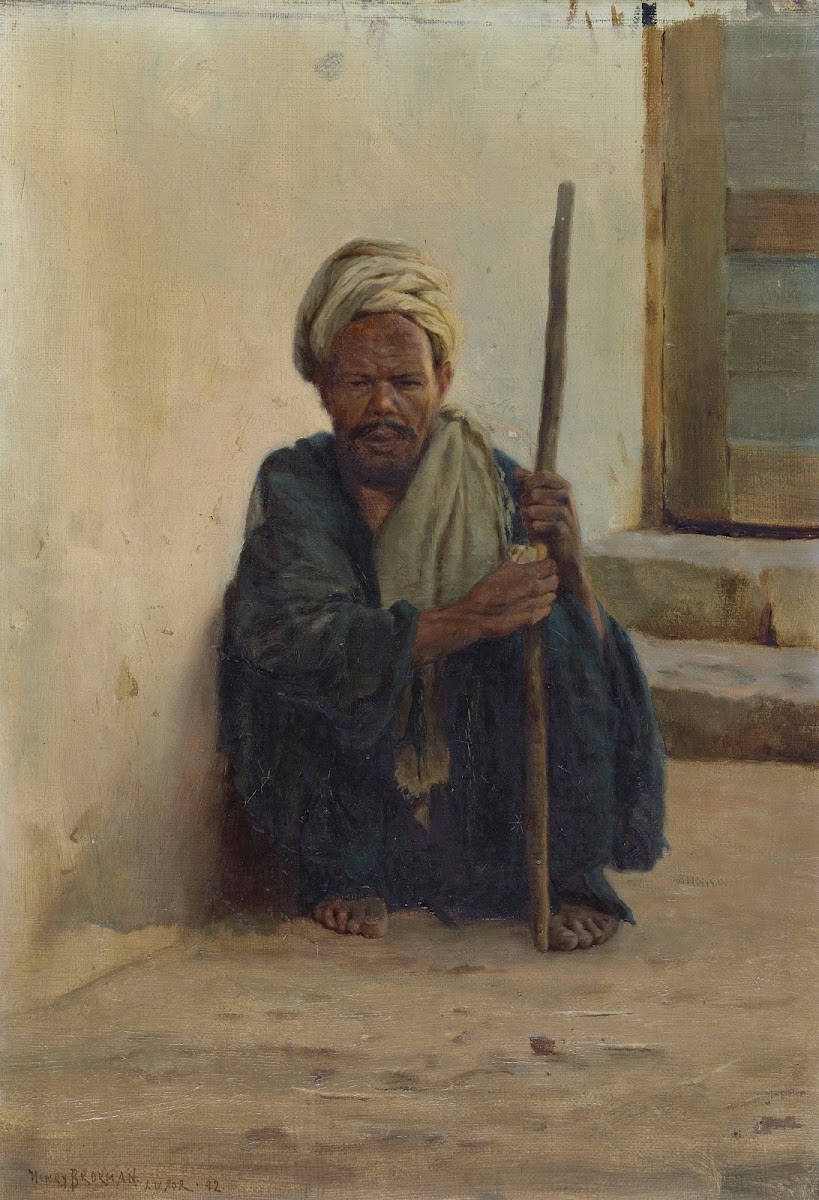 Louxor arabe tenant un bâton assis dans une rue ca 1892