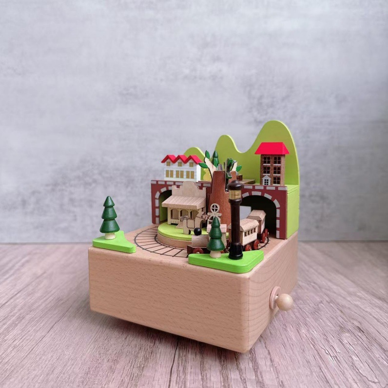 Manual music box made of beech wood with train motif