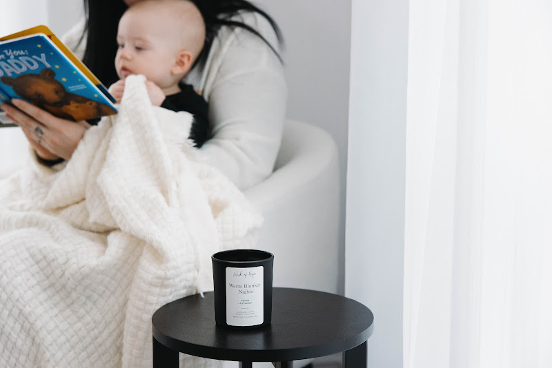 Mom and baby enjoying a peaceful moment with candle