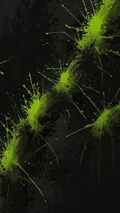 Vibrant neon green paint splatters on dark textured background
