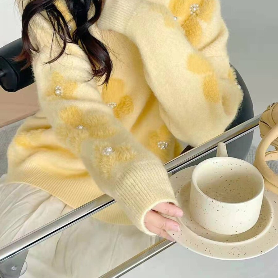 Women's knitted sweater with floral pattern and pearl embellishment